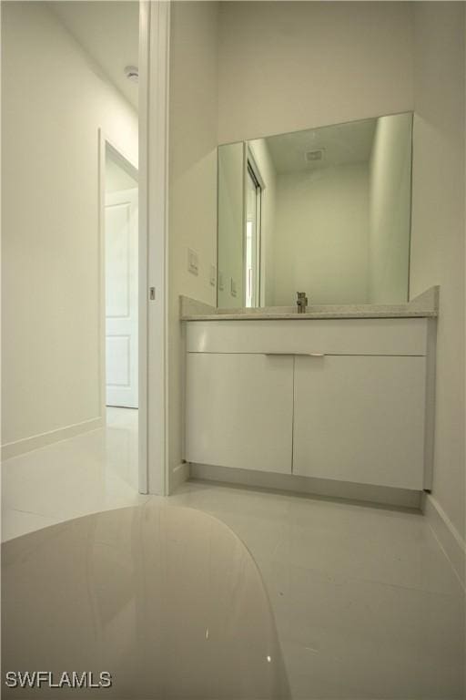 3610 22nd St SW, Lehigh Acres, FL 33976 - bathroom featuring baseboards and a sink