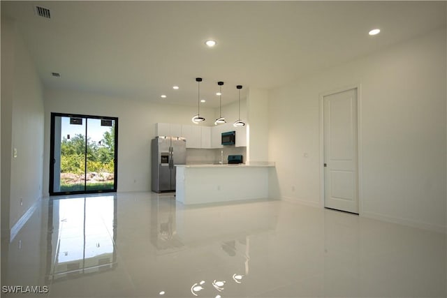 3610 22nd St SW, Lehigh Acres, FL 33976 - kitchen with black microwave, stainless steel fridge with ice dispenser, recessed lighting, and visible vents
