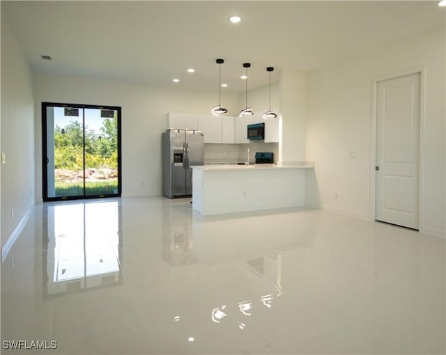 3610 22nd St SW, Lehigh Acres, FL 33976 - kitchen featuring light countertops, white cabinets, a peninsula, stainless steel appliances, and light tile patterned flooring