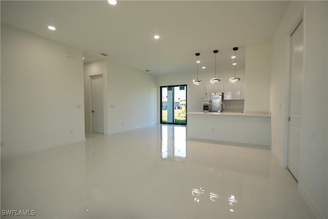 3610 22nd St SW, Lehigh Acres, FL 33976 - unfurnished living room featuring recessed lighting, baseboards, a sink, and light tile patterned floors
