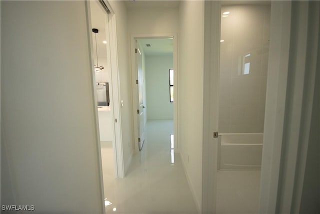 3610 22nd St SW, Lehigh Acres, FL 33976 - hall featuring light tile patterned flooring and baseboards