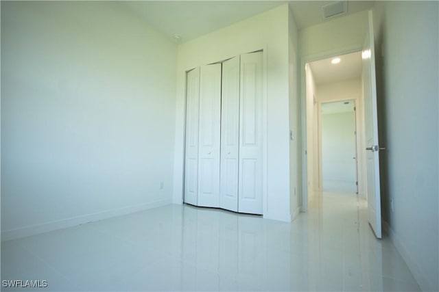 3610 22nd St SW, Lehigh Acres, FL 33976 - unfurnished bedroom with baseboards, a closet, and visible vents