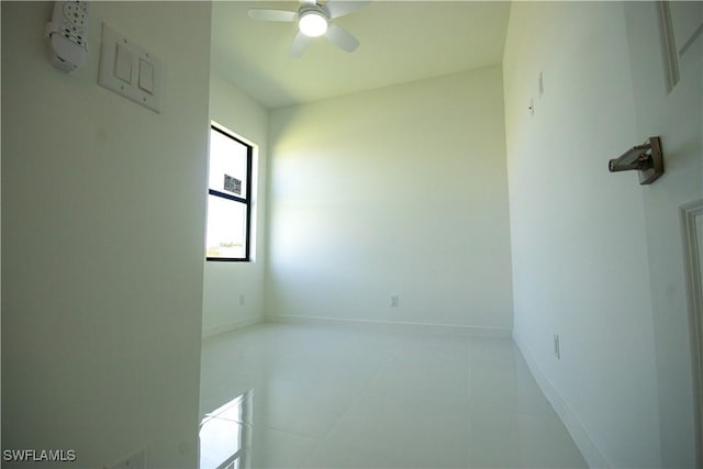 3610 22nd St SW, Lehigh Acres, FL 33976 - empty room featuring baseboards, ceiling fan, and light tile patterned flooring