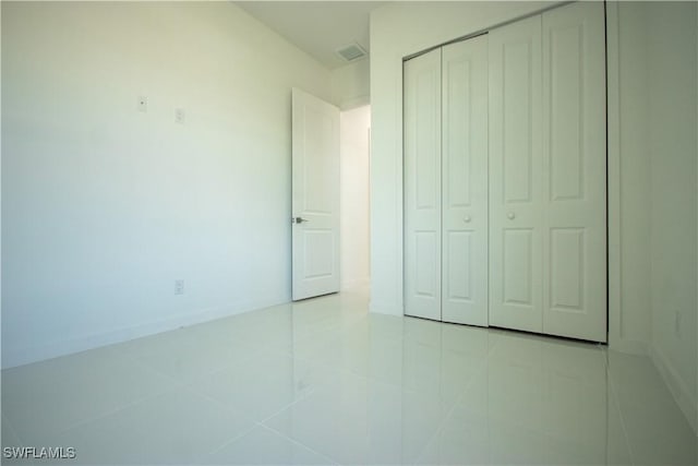 3610 22nd St SW, Lehigh Acres, FL 33976 - unfurnished bedroom with tile patterned flooring, baseboards, visible vents, and a closet