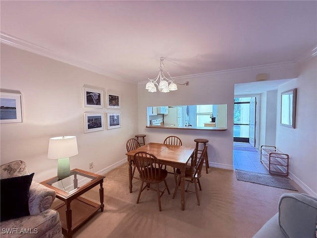 carpeted dining room featuring crown molding, baseboards, and a notable chandelier