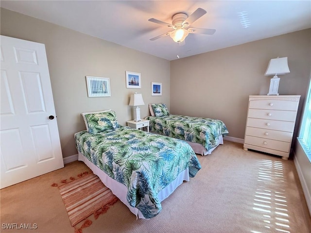 carpeted bedroom with baseboards and ceiling fan