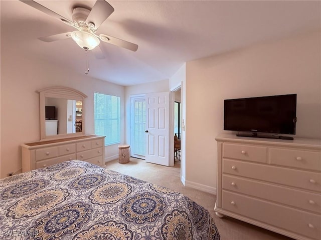 bedroom featuring baseboards, light carpet, and ceiling fan