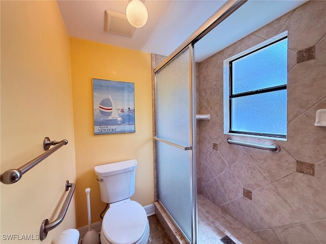 full bath with visible vents, toilet, and a shower stall