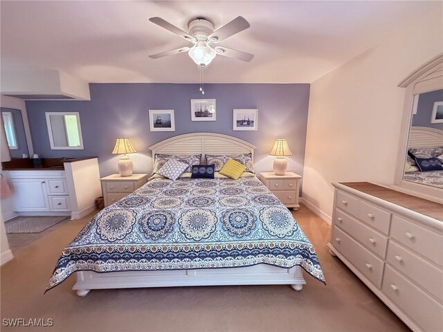 bedroom featuring baseboards, a ceiling fan, and light carpet
