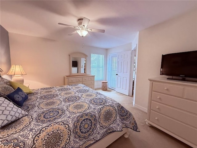 bedroom with baseboards, a ceiling fan, and light colored carpet