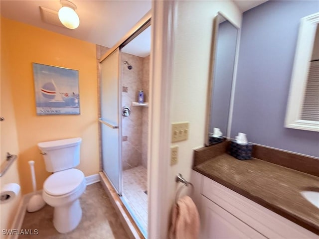 full bath featuring vanity, toilet, tile patterned floors, and a stall shower