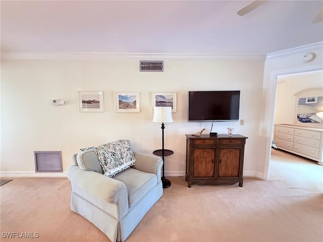 living area with carpet floors, crown molding, visible vents, and baseboards