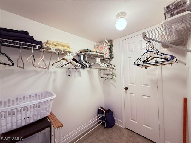 walk in closet with tile patterned flooring