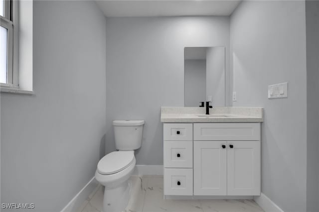 755 Milano Ave S, Lehigh Acres, FL 33974 - bathroom with baseboards, marble finish floor, toilet, and vanity
