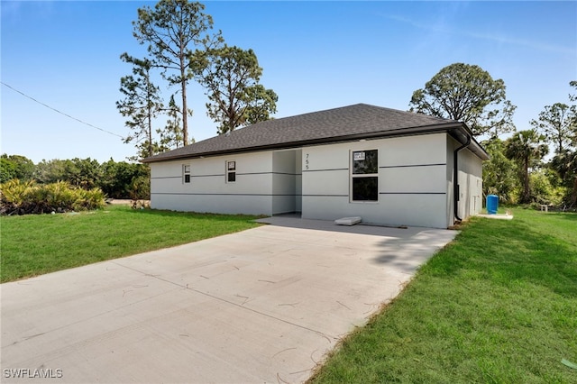 755 Milano Ave S, Lehigh Acres, FL 33974 - view of front of house featuring a patio, a shingled roof, a front yard, and stucco siding