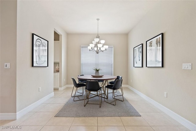 dining space with baseboards, an inviting chandelier, and light tile patterned floors