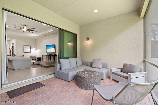 exterior space with recessed lighting, a textured wall, and ceiling fan