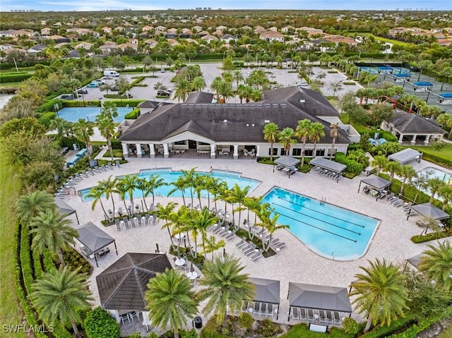 pool with a patio and a residential view