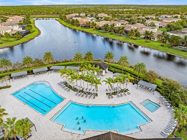 community pool featuring a residential view and a water view
