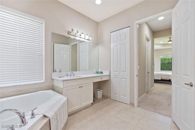 full bath with tile patterned flooring, a closet, vanity, recessed lighting, and a bath