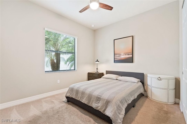 bedroom featuring carpet floors, a ceiling fan, and baseboards