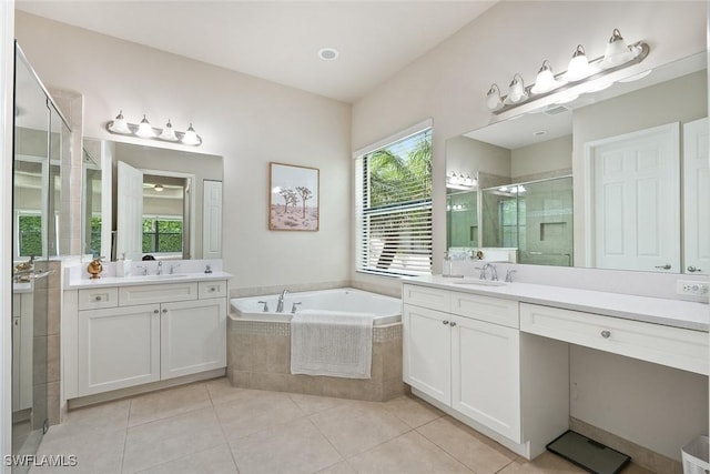 full bathroom with a sink, tile patterned floors, two vanities, a shower stall, and a garden tub