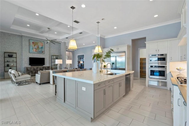 kitchen featuring a ceiling fan, crown molding, a sink, stainless steel appliances, and recessed lighting