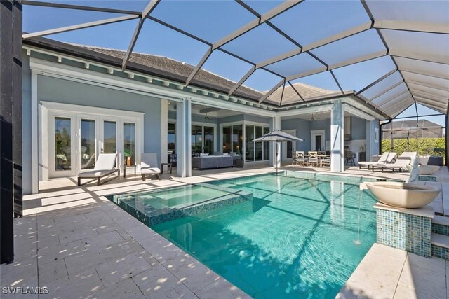 6250 Lightbourn Way, Naples, FL 34113 - rear view of property with a pool with connected hot tub, an outdoor hangout area, a patio area, a ceiling fan, and a lanai
