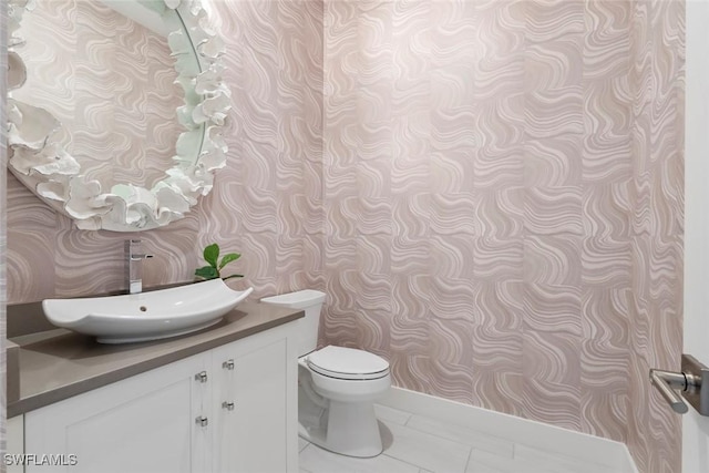 6250 Lightbourn Way, Naples, FL 34113 - half bath with vanity, toilet, and wallpapered walls