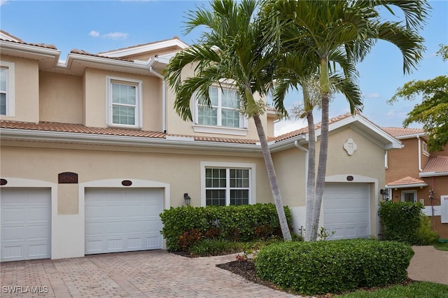 view of front of property with decorative driveway and stucco siding