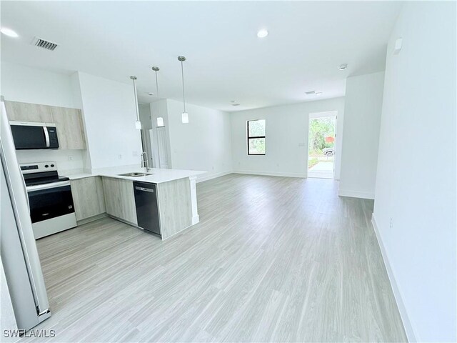 5010 Day Ln, Labelle, FL 33935 - kitchen featuring electric range, a sink, dishwasher, stainless steel microwave, and modern cabinets