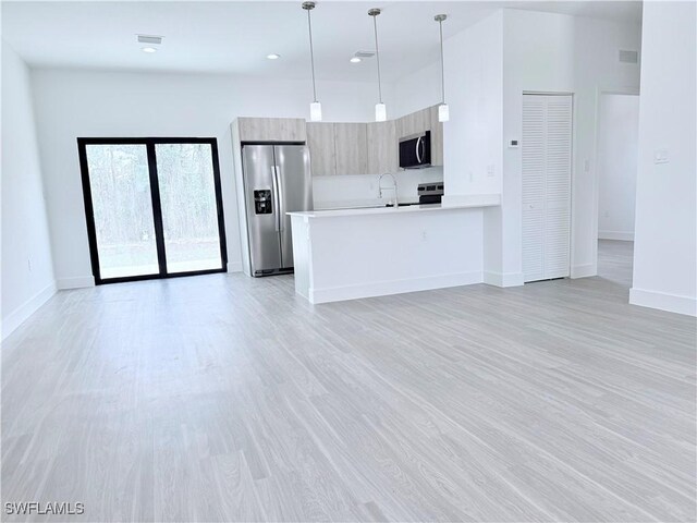 5010 Day Ln, Labelle, FL 33935 - kitchen featuring light countertops, open floor plan, appliances with stainless steel finishes, and modern cabinets