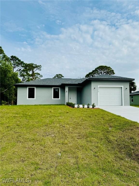 5010 Day Ln, Labelle, FL 33935 - ranch-style home with concrete driveway, a garage, a front lawn, and stucco siding