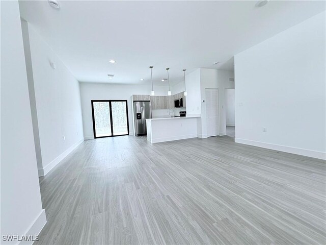 5010 Day Ln, Labelle, FL 33935 - unfurnished living room featuring baseboards and light wood-style floors