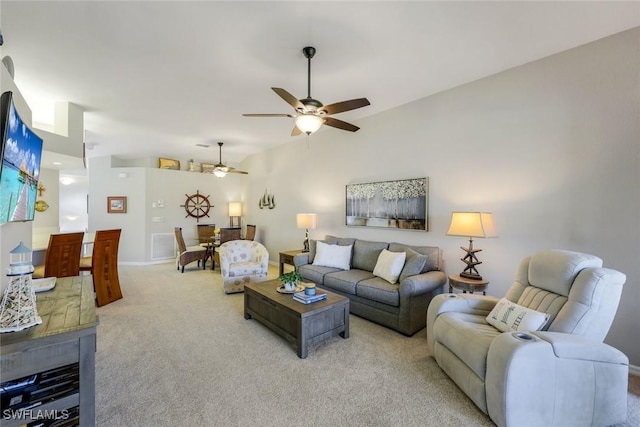 living area featuring baseboards, a ceiling fan, lofted ceiling, and light carpet