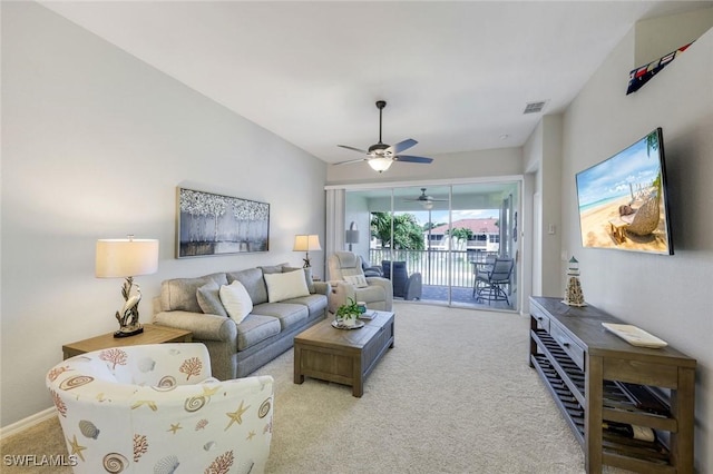 living room with ceiling fan, light colored carpet, and visible vents