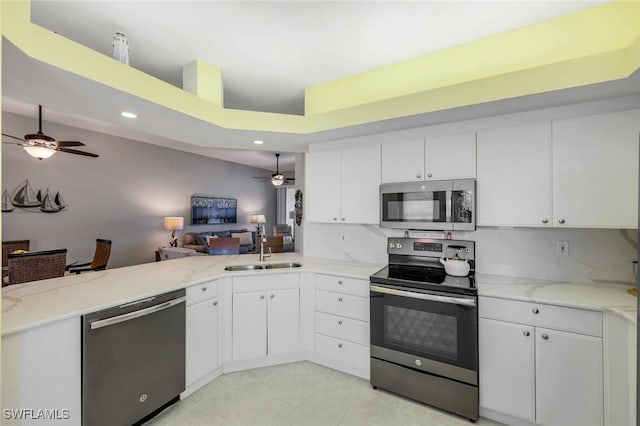 kitchen featuring recessed lighting, ceiling fan, appliances with stainless steel finishes, and a sink