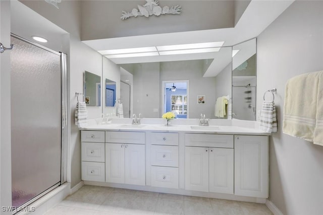 full bath featuring double vanity, a sink, and a stall shower