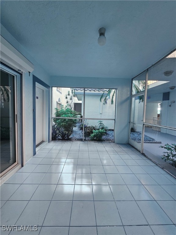 6025 Chardonnay Ln Unit 102, Naples, FL 34119 - unfurnished sunroom with plenty of natural light