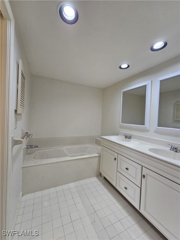 6025 Chardonnay Ln Unit 102, Naples, FL 34119 - bathroom with double vanity, a bath, recessed lighting, and tile patterned flooring