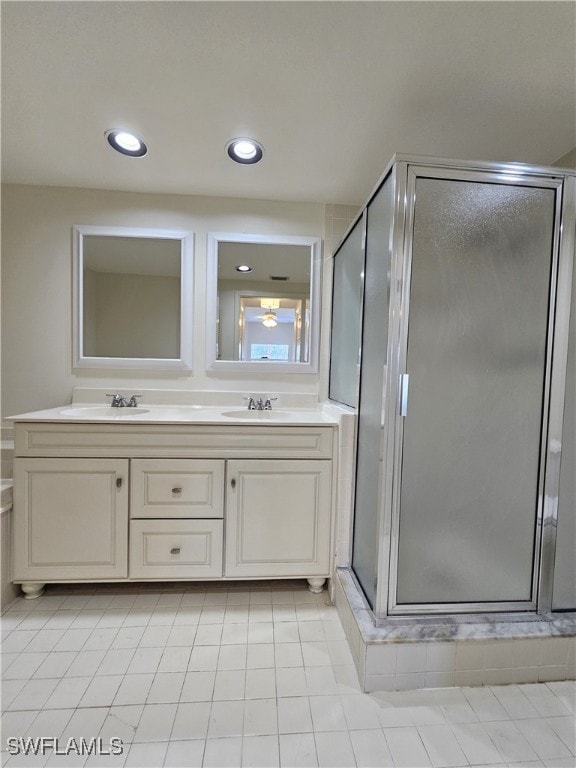 6025 Chardonnay Ln Unit 102, Naples, FL 34119 - full bathroom featuring a shower stall, double vanity, tile patterned floors, and recessed lighting