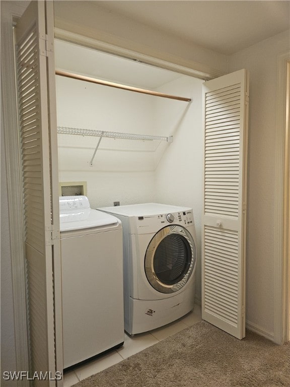 6025 Chardonnay Ln Unit 102, Naples, FL 34119 - clothes washing area with washing machine and dryer and light tile patterned floors