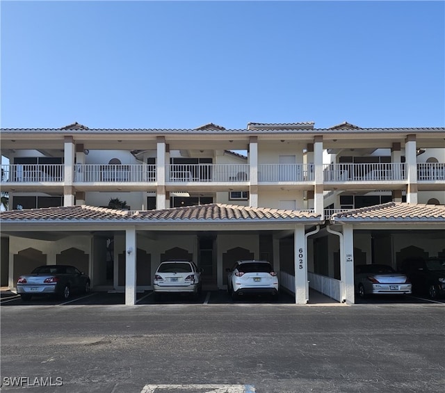 6025 Chardonnay Ln Unit 102, Naples, FL 34119 - view of front of house featuring a tiled roof and covered parking