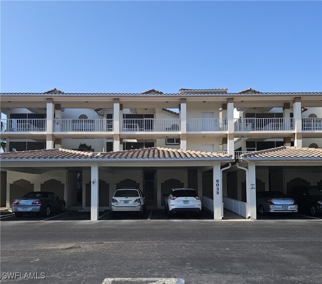 6025 Chardonnay Ln Unit 102, Naples, FL 34119 - exterior space with a tiled roof and covered parking
