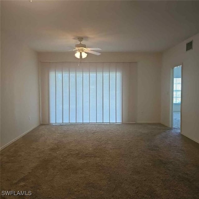 6025 Chardonnay Ln Unit 102, Naples, FL 34119 - empty room featuring a ceiling fan, carpet, and baseboards