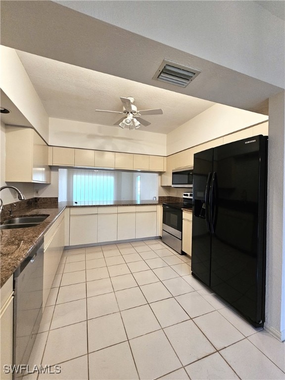 6025 Chardonnay Ln Unit 102, Naples, FL 34119 - kitchen with stainless steel appliances, light tile patterned flooring, dark countertops, ceiling fan, and a peninsula