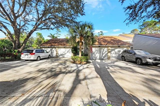 view of front of property with concrete driveway and a garage