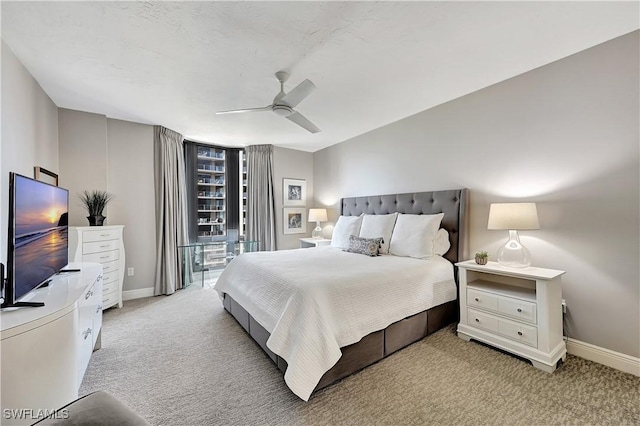 bedroom with baseboards, ceiling fan, and light carpet