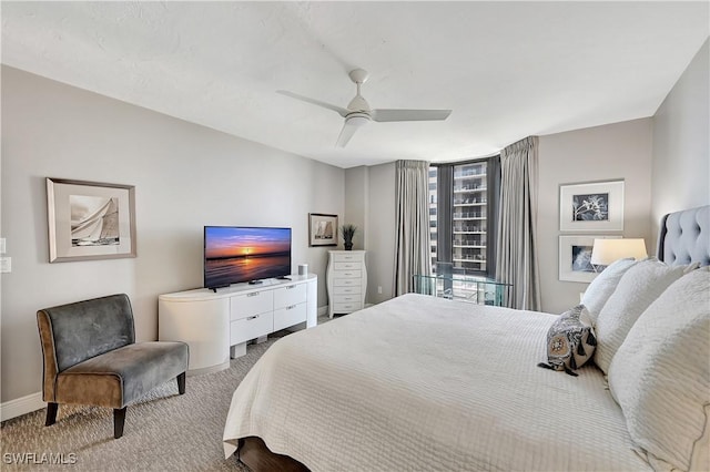 carpeted bedroom featuring a ceiling fan and baseboards