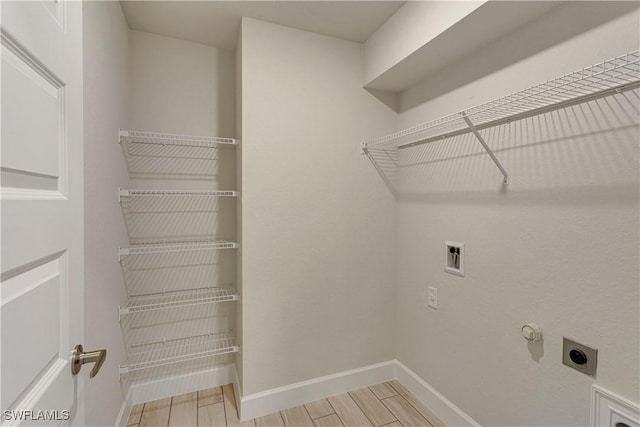 laundry room featuring washer hookup, laundry area, electric dryer hookup, hookup for a gas dryer, and baseboards